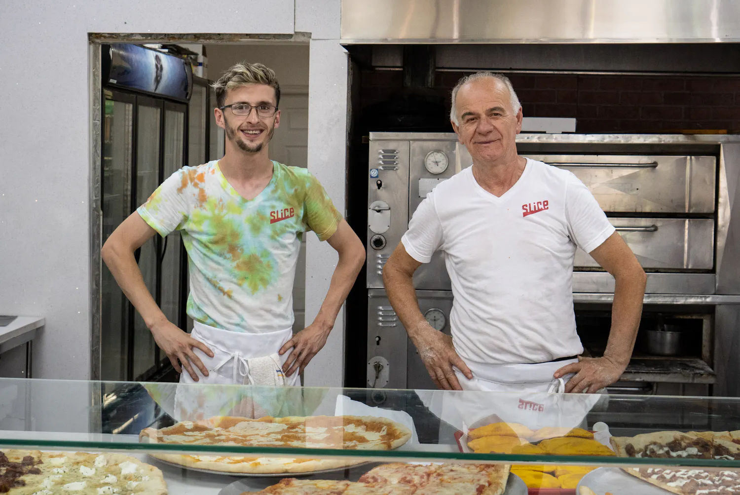 Pizza Mia staff standing in front of the pizza oven in Staten Island